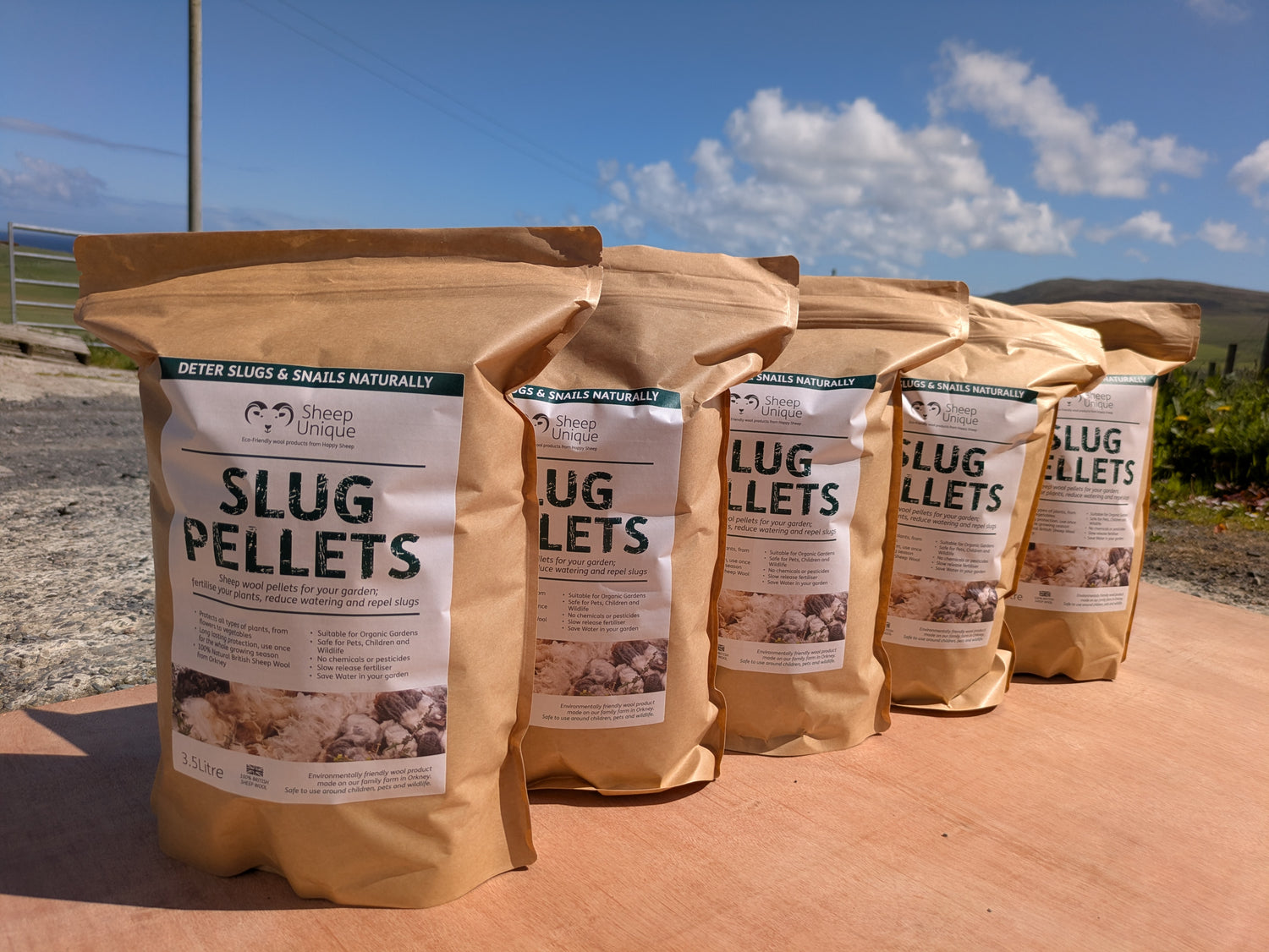 Five bags of Slug Pellets with a scenic background