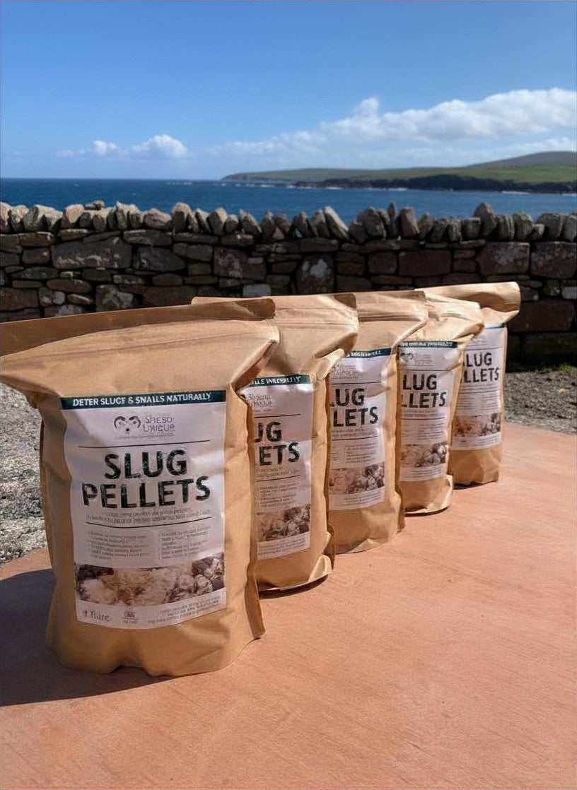 Bags of slug pellets with a scenic background of water and sky.