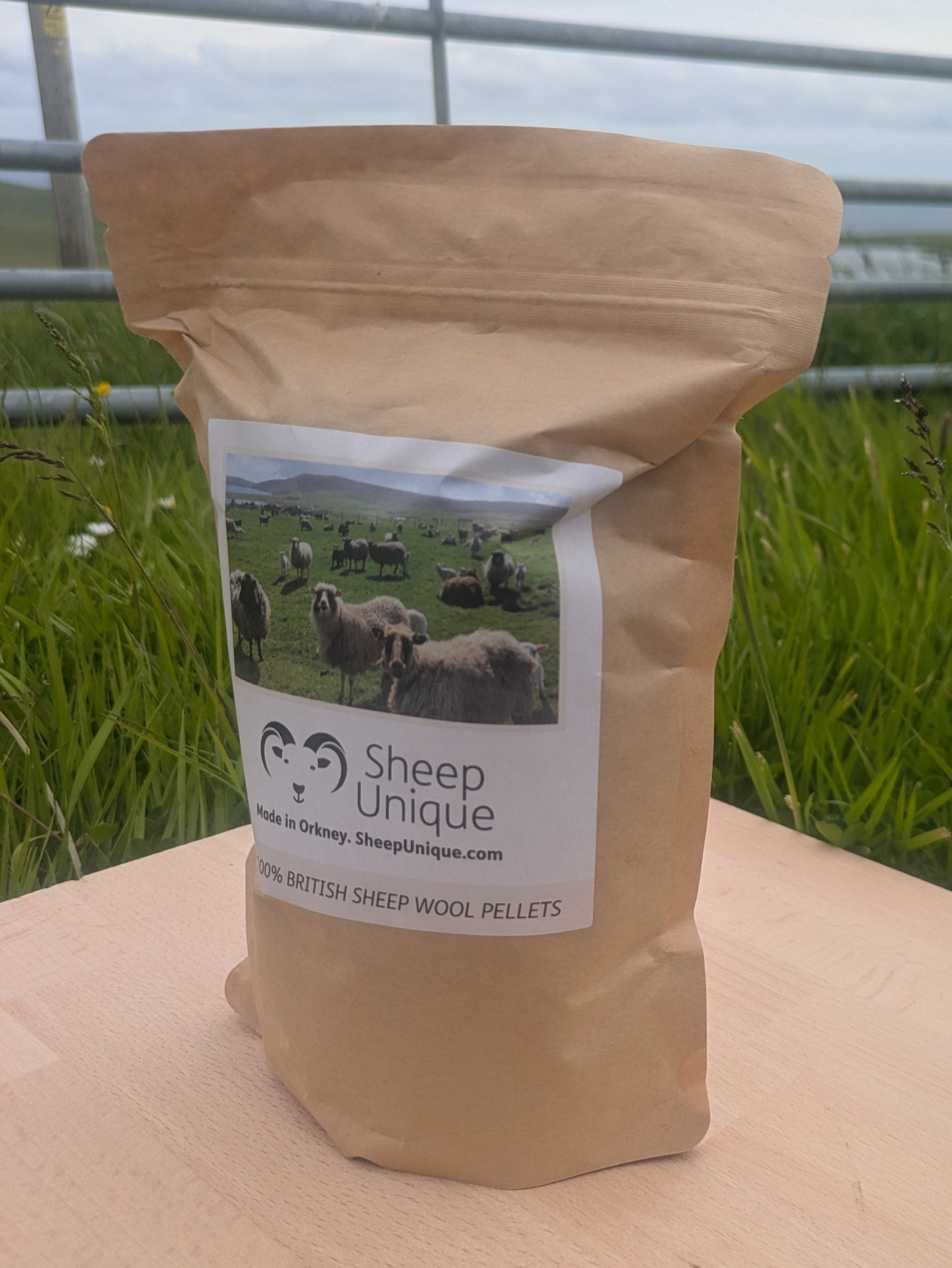 Bag of Sheep Unique wool pellets with a scenic label on a wooden surface.