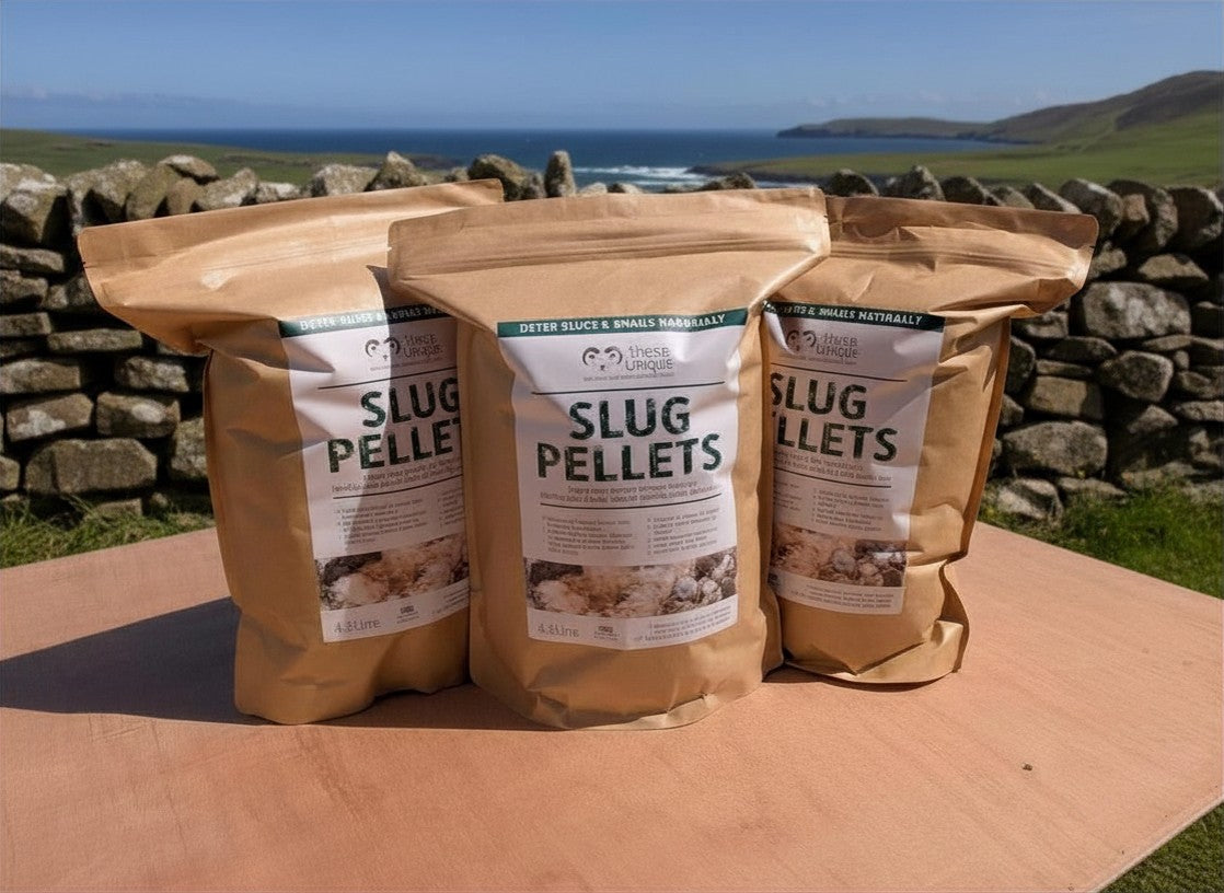 Three bags of slug pellets with a scenic background of stone walls and open fields.