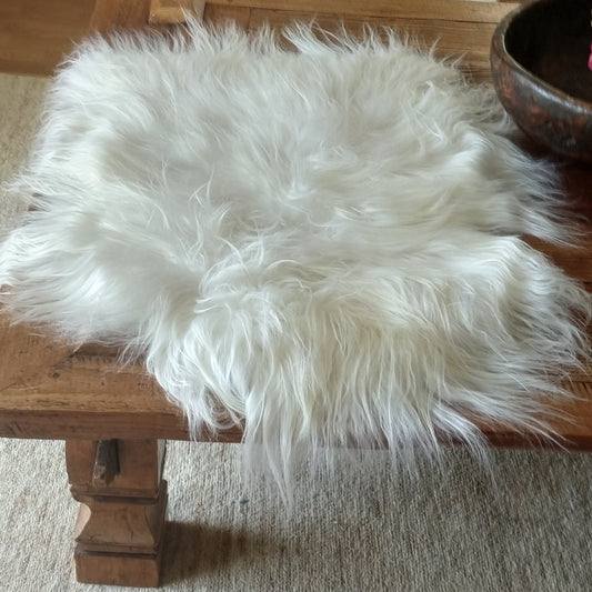 Large White Sheepskin Rug on a table